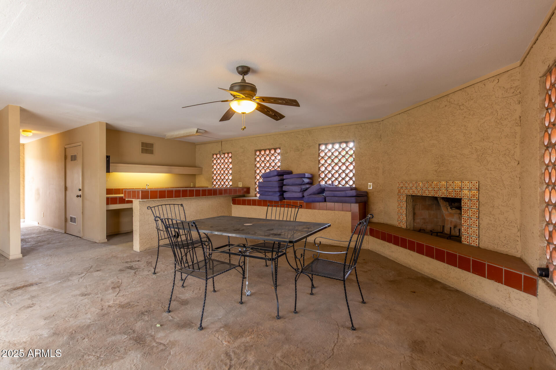 2059 East Brown Road, Unit 30 Mesa, AZ 85213 - Photo 23 of 24 a view of a dining room with furniture and a fireplace