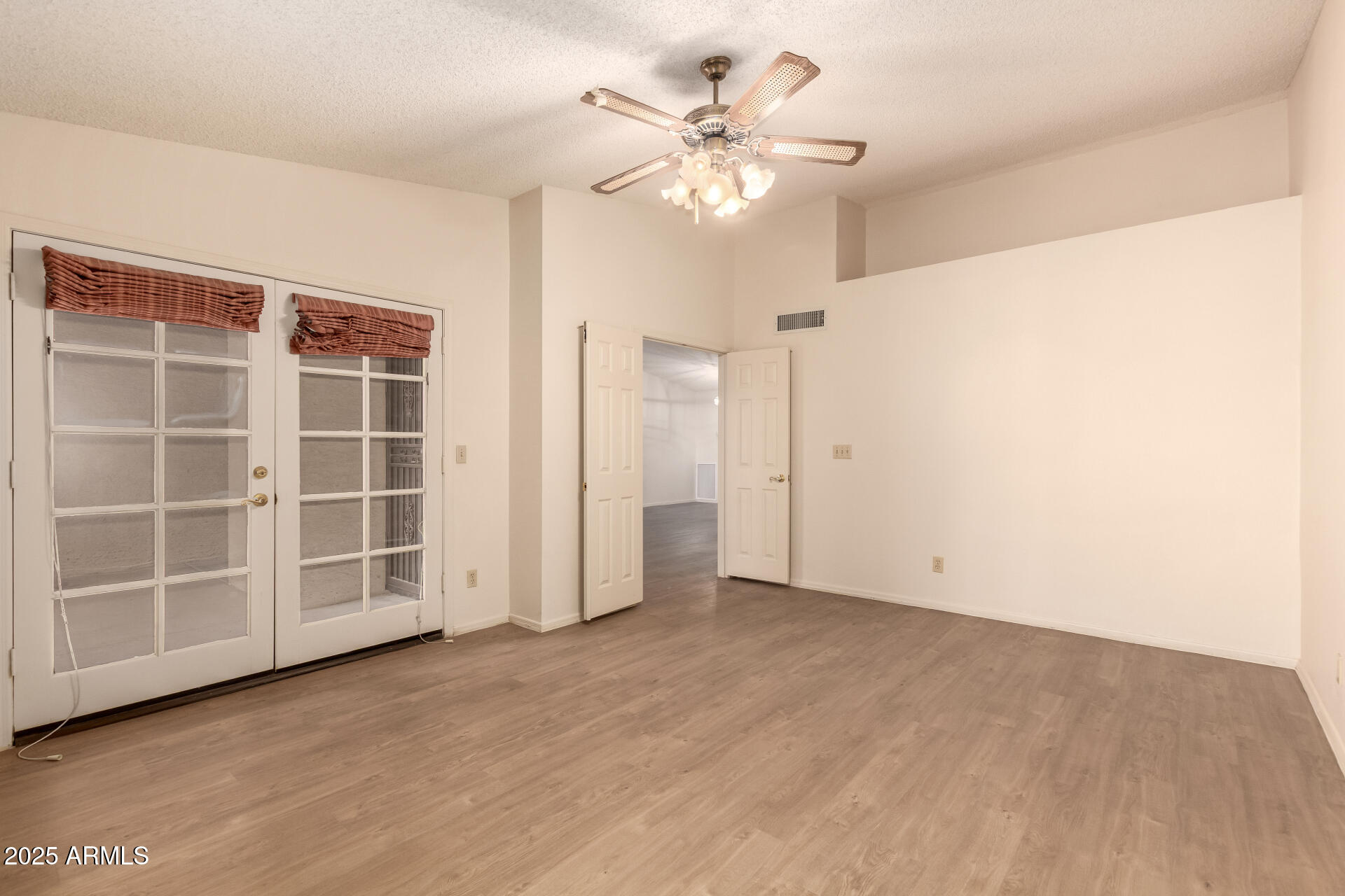 2059 East Brown Road, Unit 30 Mesa, AZ 85213 - Photo 9 of 24 wooden floor in an empty room with a window