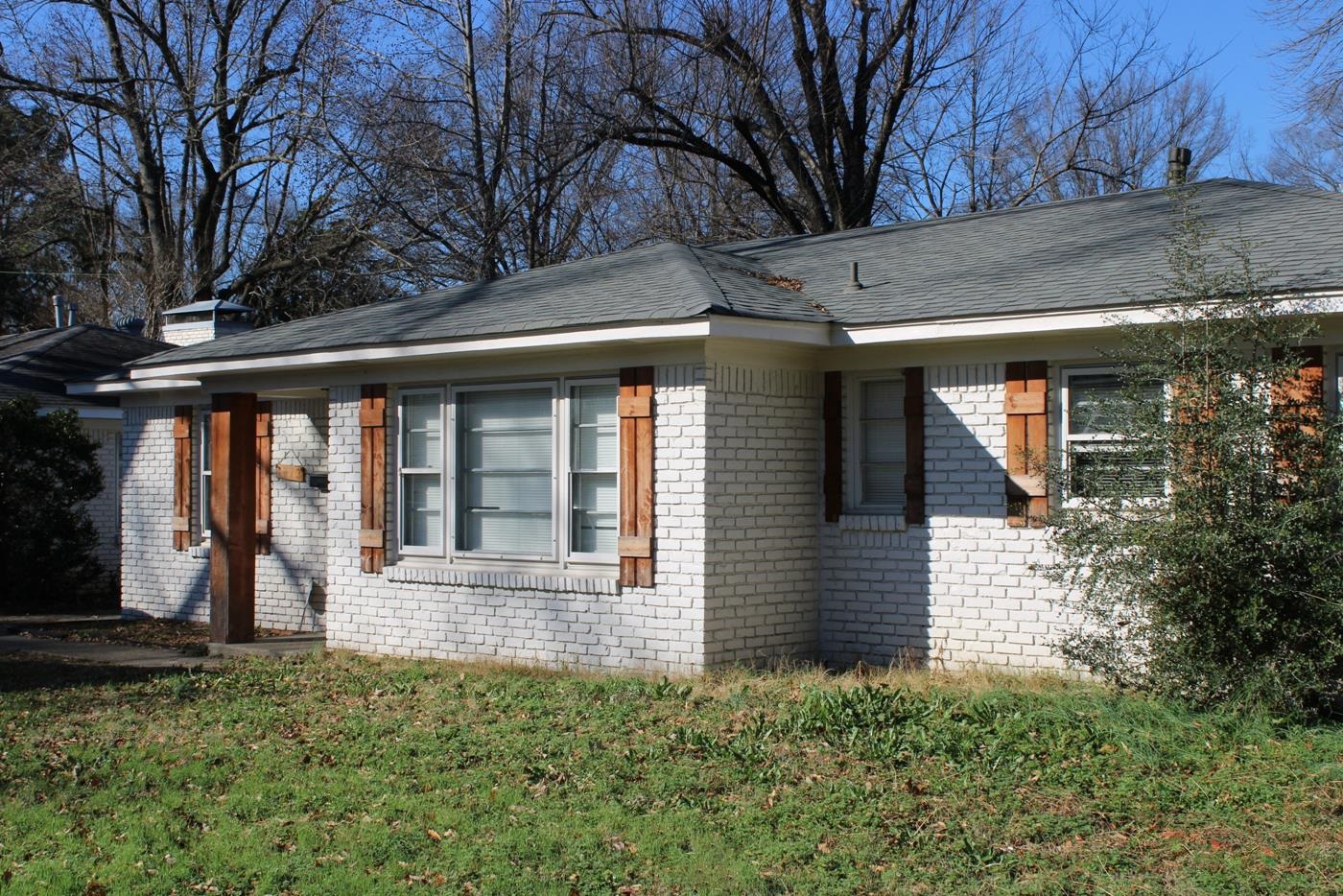 1673 South White Station Road Memphis, TN 38117 - Photo 1 of 17 View of side of home with brick siding, a lawn, a chimney, and roof with shingles