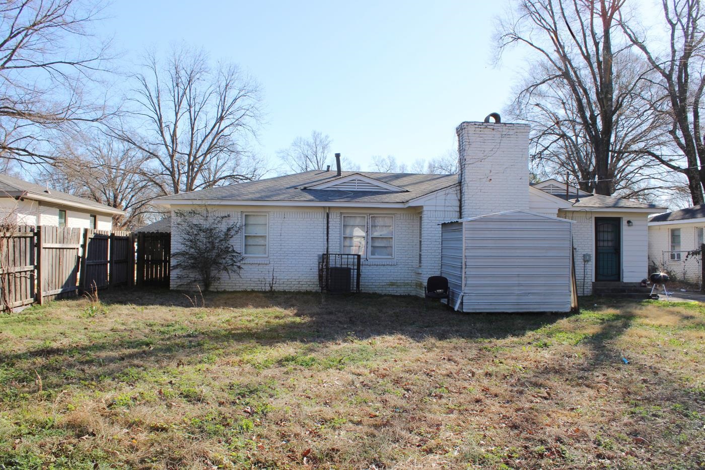 1673 South White Station Road Memphis, TN 38117 - Photo 11 of 17 Rear view of property featuring brick siding and a chimney