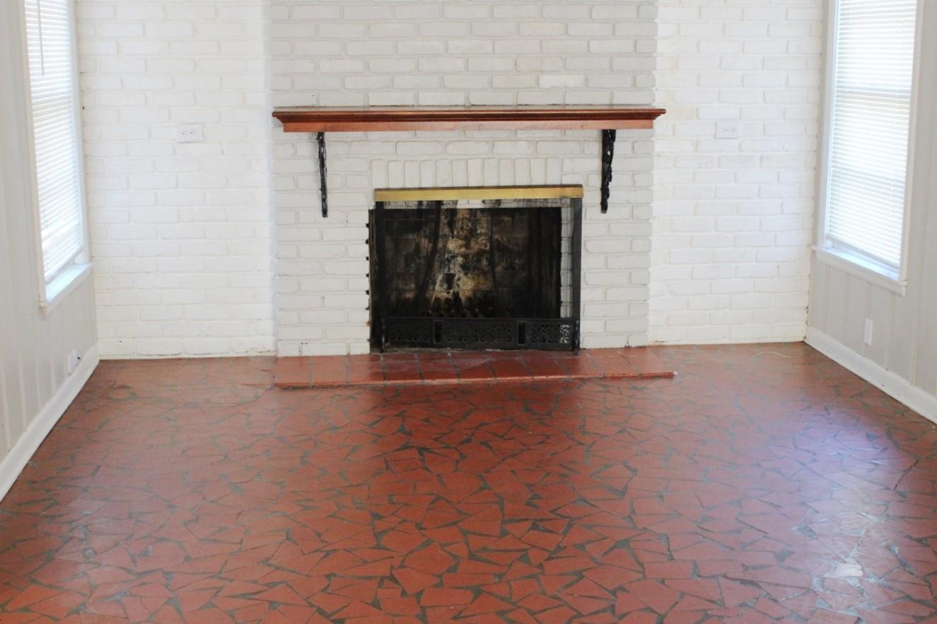 1673 South White Station Road Memphis, TN 38117 - Photo 12 of 17 Detailed view of baseboards and a brick fireplace