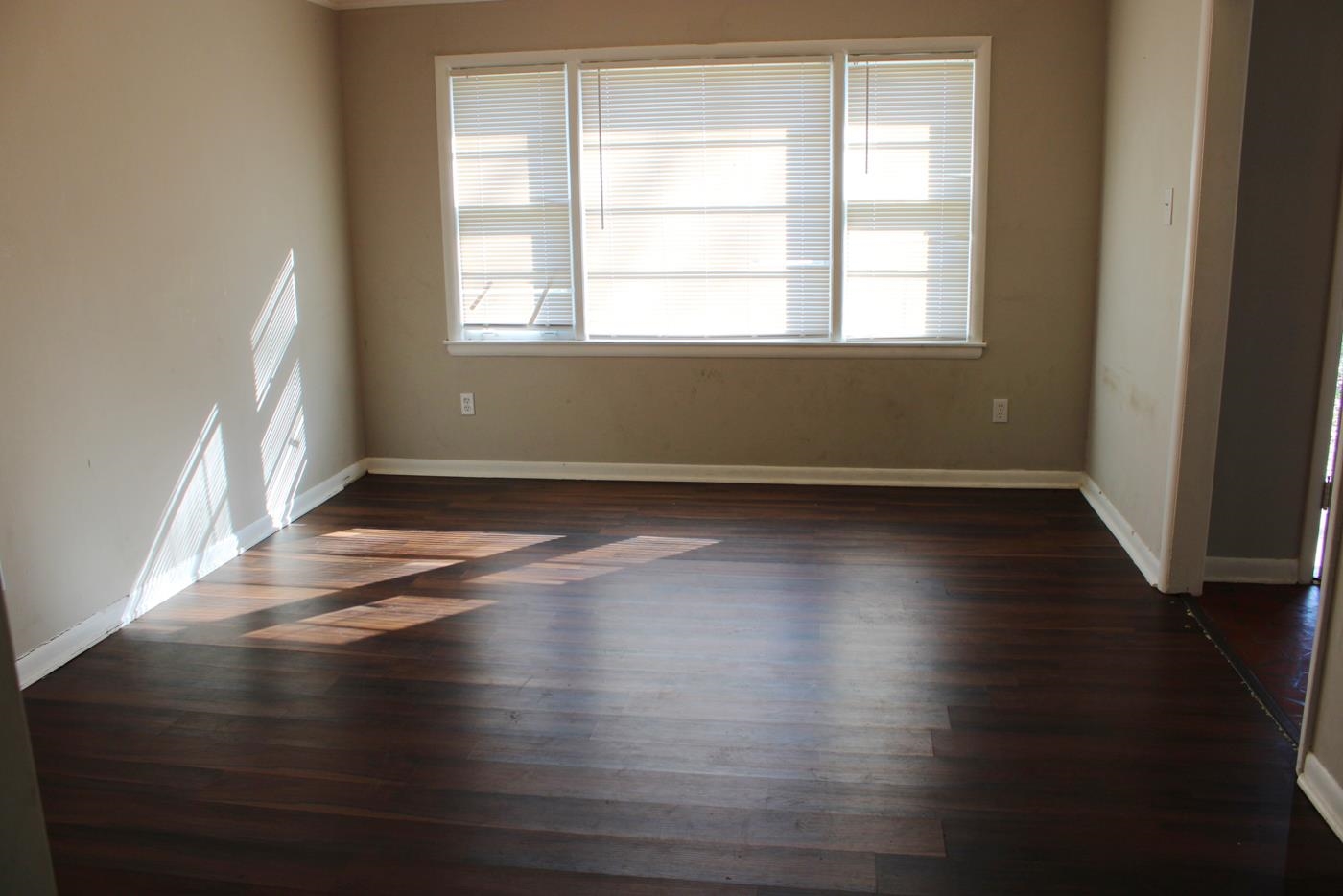 1673 South White Station Road Memphis, TN 38117 - Photo 2 of 17 Spare room with plenty of natural light and dark wood finished floors