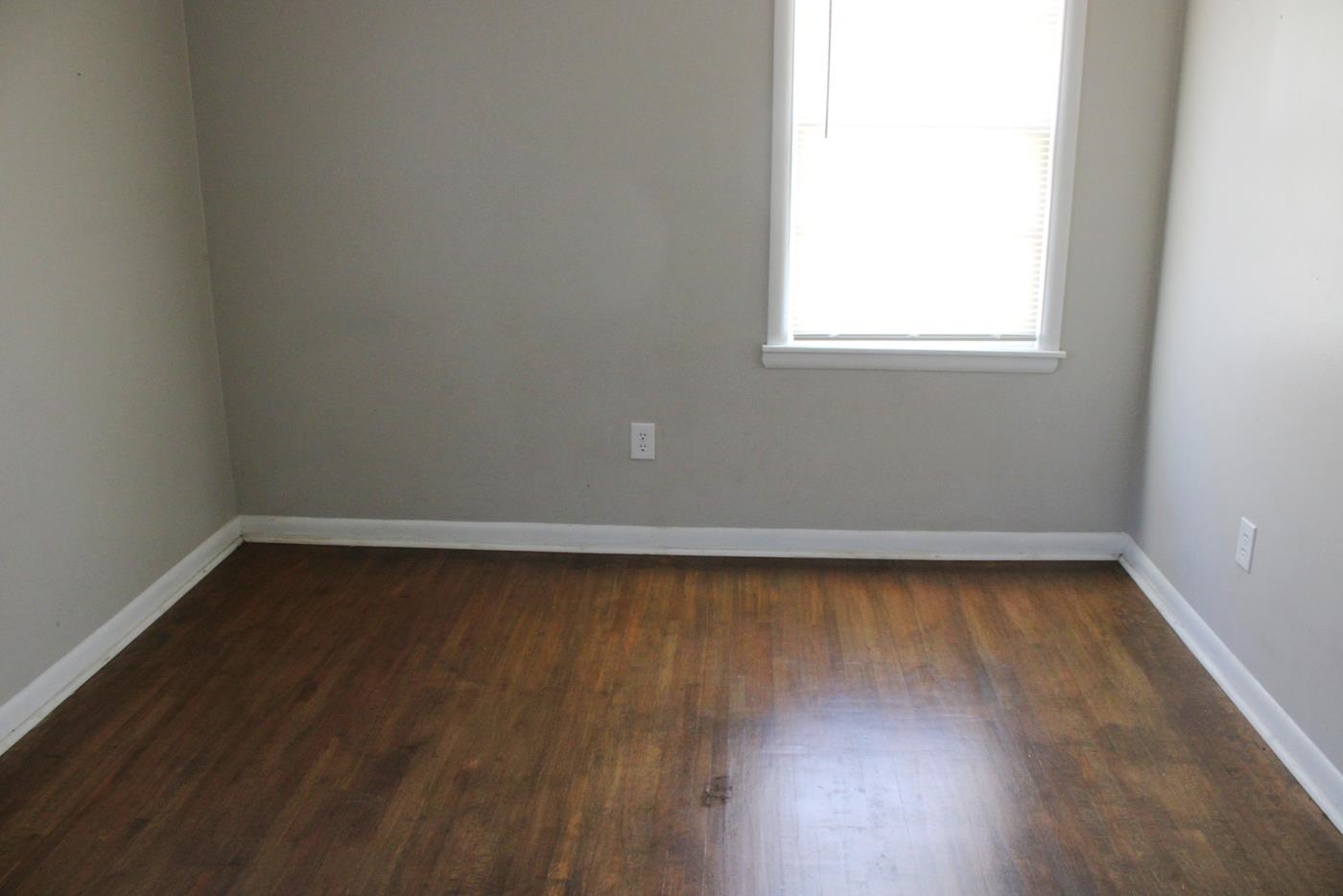 1673 South White Station Road Memphis, TN 38117 - Photo 6 of 17 Unfurnished room with dark wood-style floors and baseboards