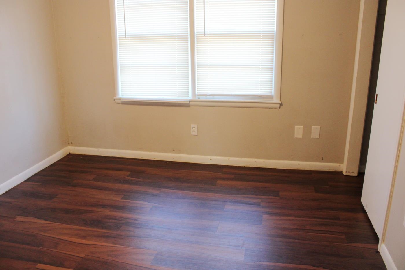 1673 South White Station Road Memphis, TN 38117 - Photo 7 of 17 Spare room with dark wood finished floors and plenty of natural light