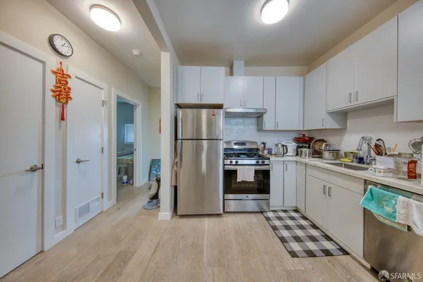 a kitchen with stainless steel appliances granite countertop a refrigerator oven a sink and dishwasher