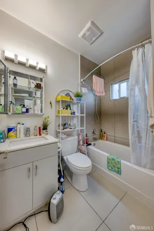 a bathroom with a sink mirror vanity and toilet
