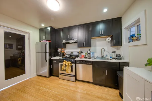 a kitchen with stainless steel appliances granite countertop a refrigerator and a sink