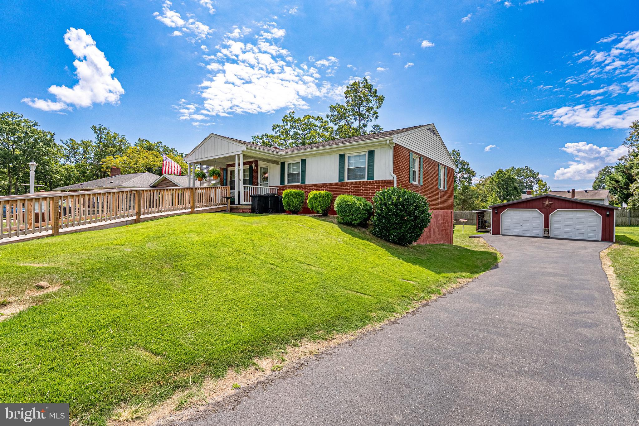 14100 Brant Road Southwest Cumberland, MD 21502 - Photo 1 of 40 a front view of a house with a yard and potted plants