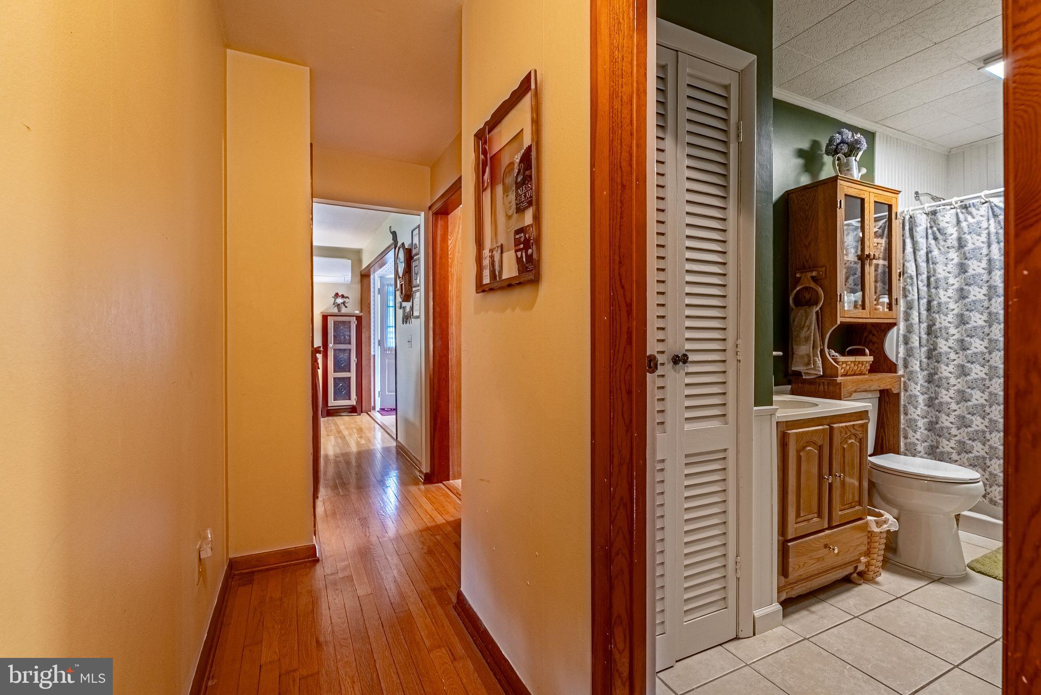 14100 Brant Road Southwest Cumberland, MD 21502 - Photo 13 of 40 a bathroom with a toilet a sink and mirror
