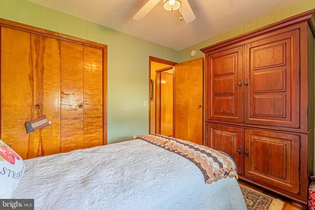 a bedroom with a bed and sliding window