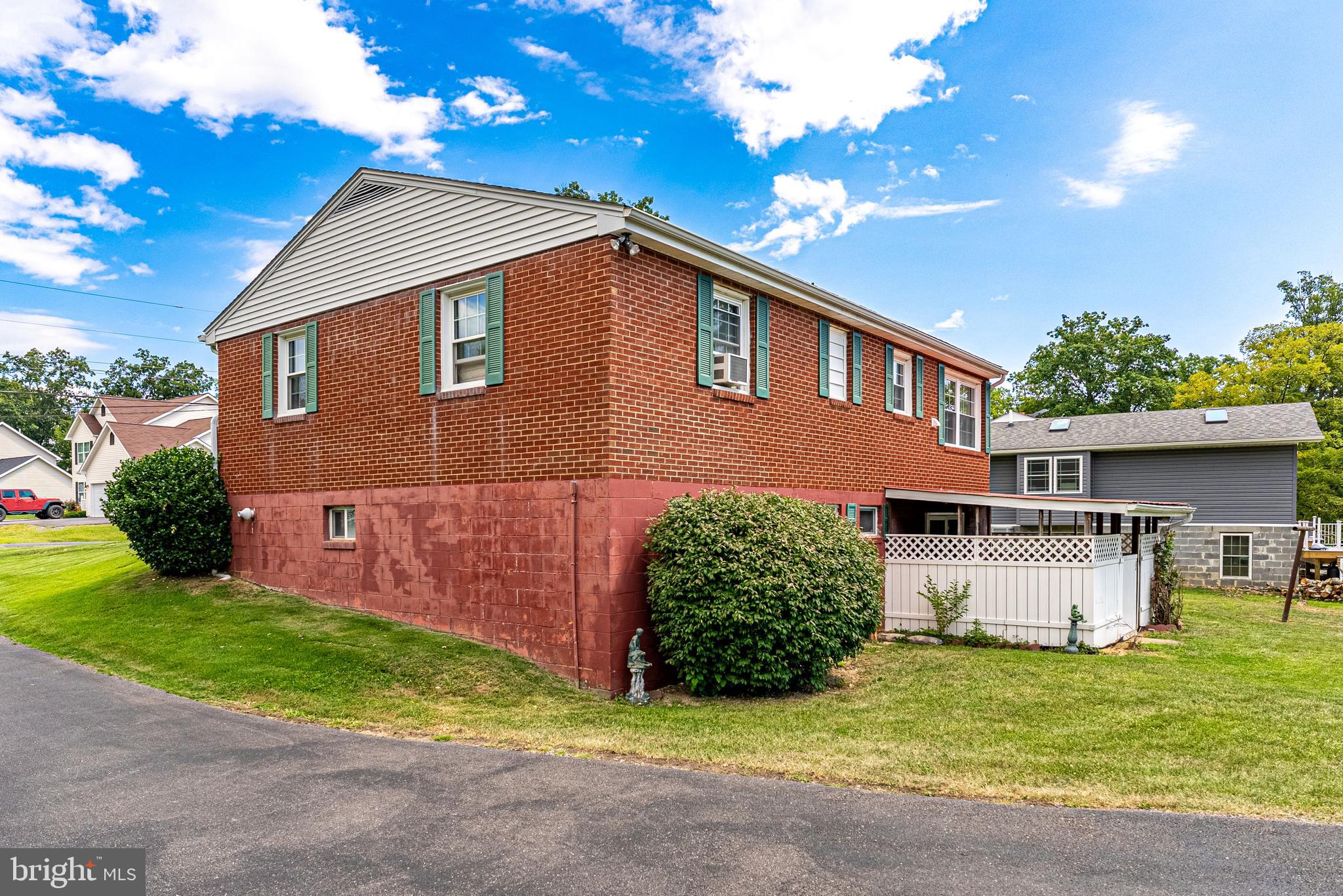14100 Brant Road Southwest Cumberland, MD 21502 - Photo 38 of 40 a front view of a house with a garden and yard