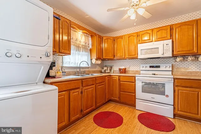 a kitchen with cabinets appliances and a window