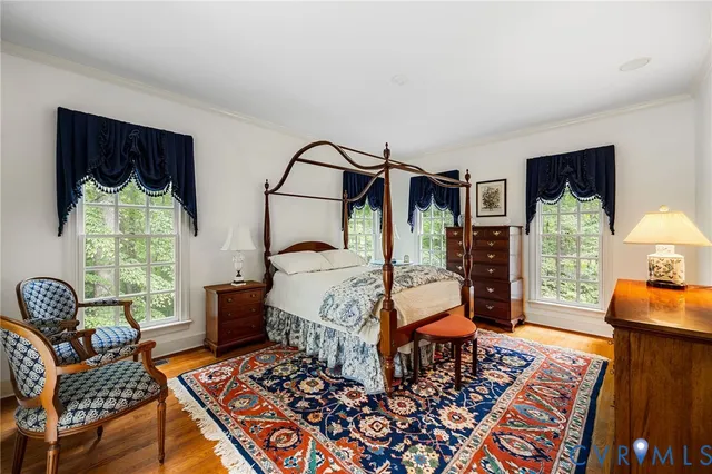 a bedroom with furniture and a rug