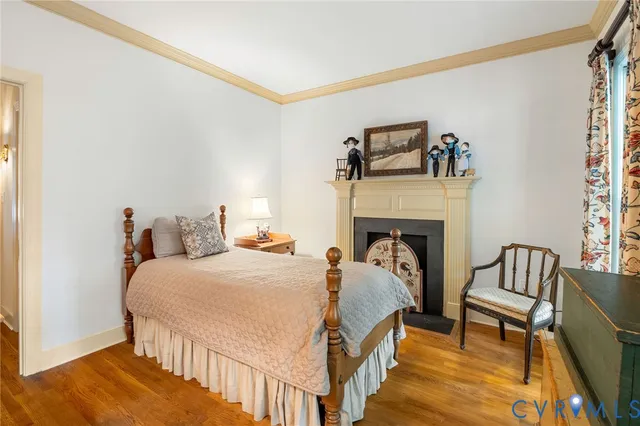 a bedroom with furniture and a fireplace
