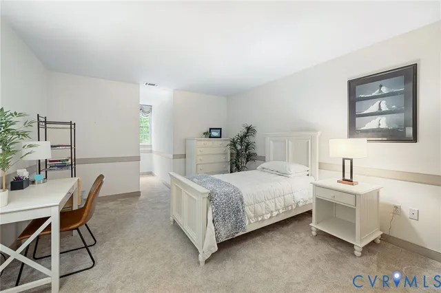 a room with a bed and a table in it