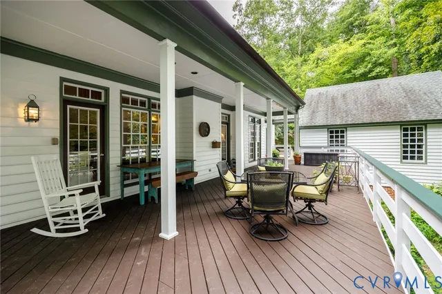 a view of a deck with table and chairs and wooden floor