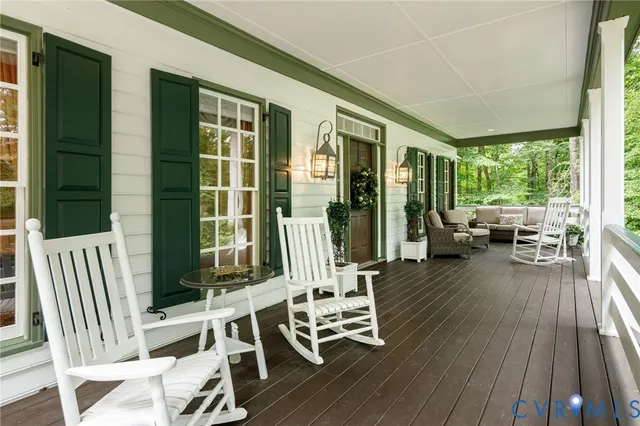 a view of a patio with table and chairs and wooden floor