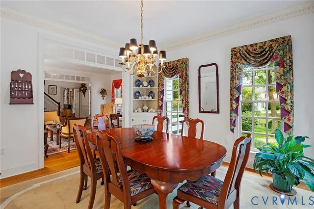 a view of a dining room with furniture and chandelier