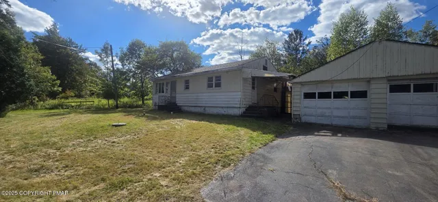 a view of a house with a yard