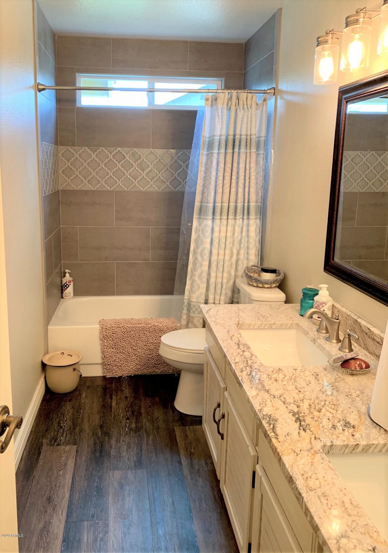 500 South Terrace Road Chandler, AZ 85226 - Photo 16 of 22 a bathroom with a granite countertop bathtub sink vanity mirror and toilet