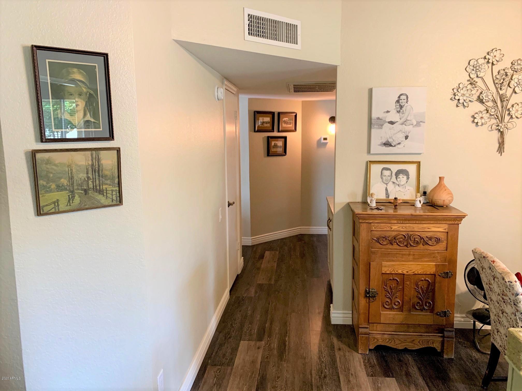 500 South Terrace Road Chandler, AZ 85226 - Photo 9 of 22 a view of a hallway with wooden floor and furniture