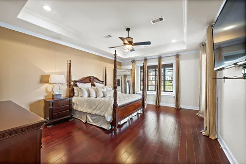 a bedroom with a bed tv and a window