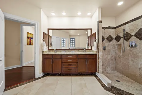 a bathroom with a sink a shower and a mirror