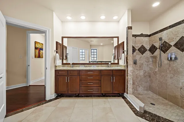 a bathroom with a sink a shower and a mirror