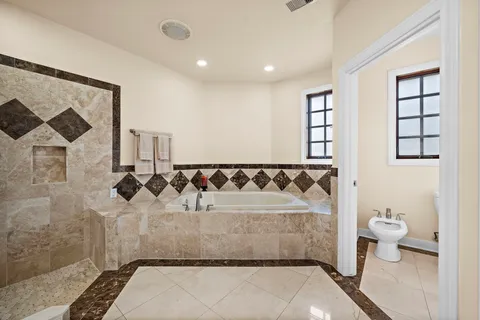a bathroom with a bathtub and shower