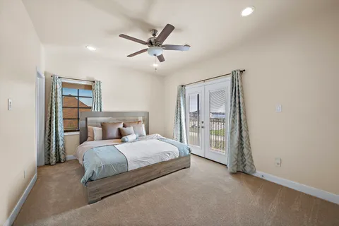 a bedroom with a large bed and a window