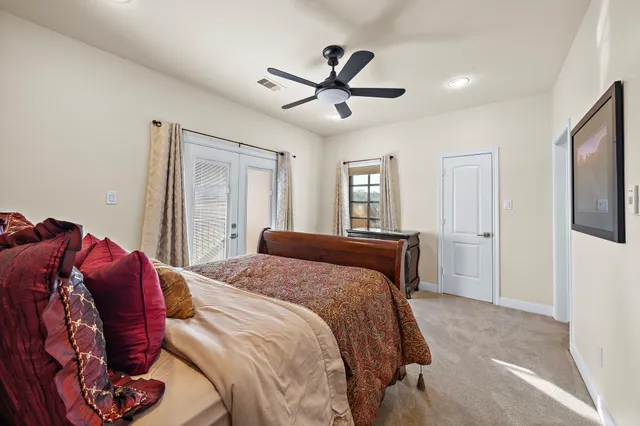 a bedroom with a large bed and a chandelier