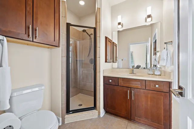 a bathroom with a granite countertop sink toilet and shower
