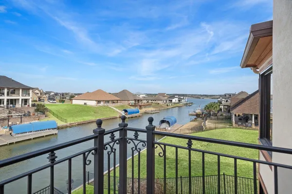 an aerial view of a house with outdoor space and lake view