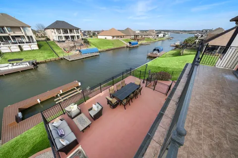 an aerial view of a house with outdoor space and lake view