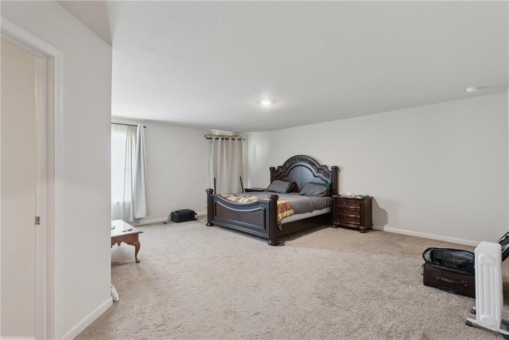 101 Foley Drive Cartersville, GA 30120 - Photo 16 of 24 a living room with furniture a mirror and a lamp on the dresser