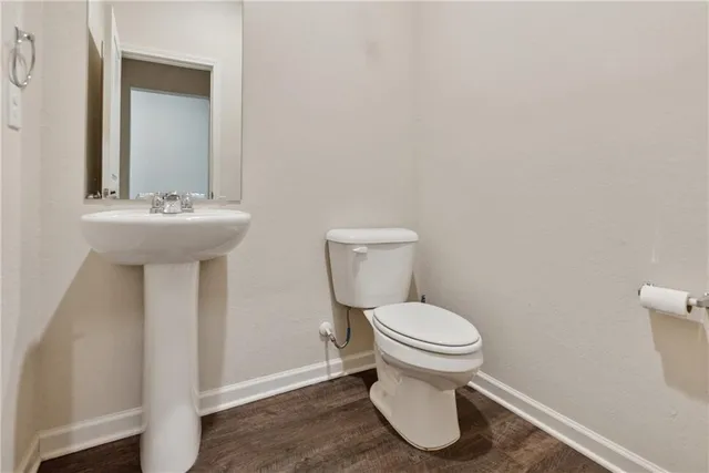 a white toilet sitting next to a bathroom sink