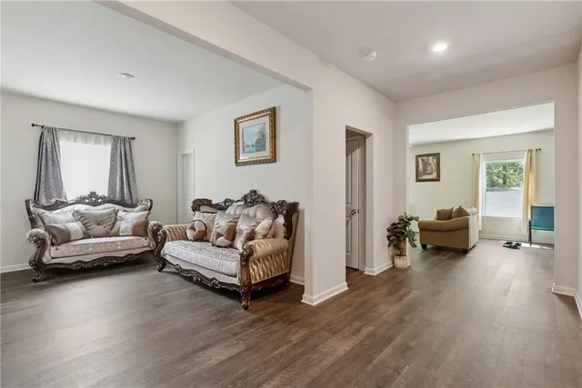 a living room with furniture and a wooden floor