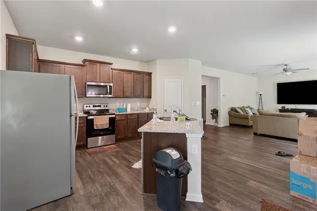 a kitchen with sink refrigerator and microwave
