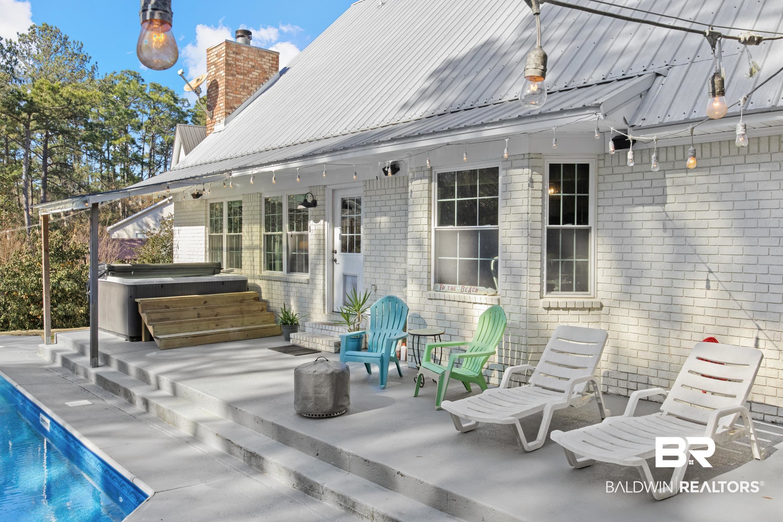 131 Marikesh Drive Daphne, AL 36526 - Photo 25 of 29 Rear view of house featuring a hot tub and a patio