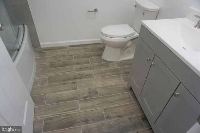 a bathroom with a toilet and a shower