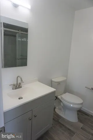 a bathroom with a sink toilet and mirror