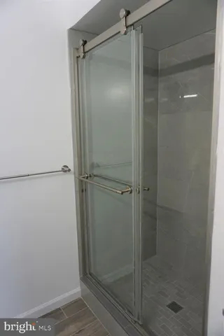 a bathroom with a glass shower door
