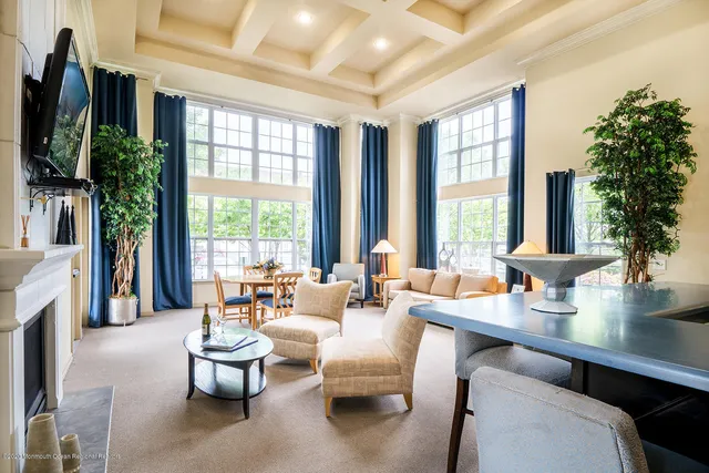 a living room with fireplace furniture and a large window