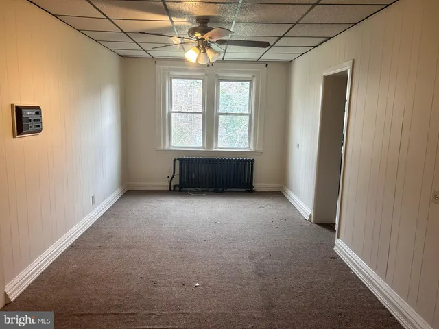 a view of room with a ceiling fan and window