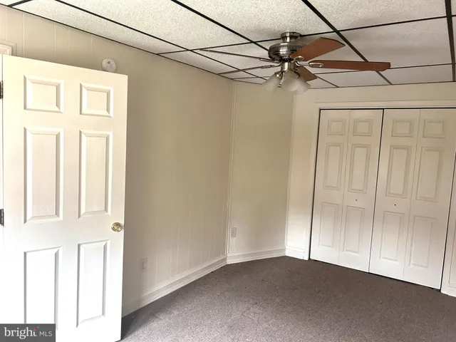a view of a livingroom with a ceiling fan and window