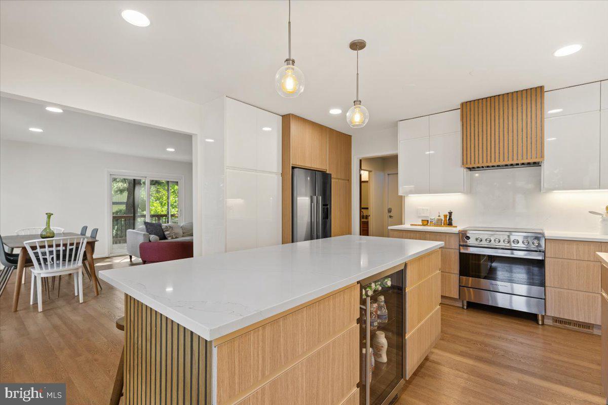 9411 Fernwood Road Bethesda, MD 20817 - Photo 16 of 101 a kitchen with stainless steel appliances granite countertop a stove a refrigerator a kitchen island a dining table and chairs