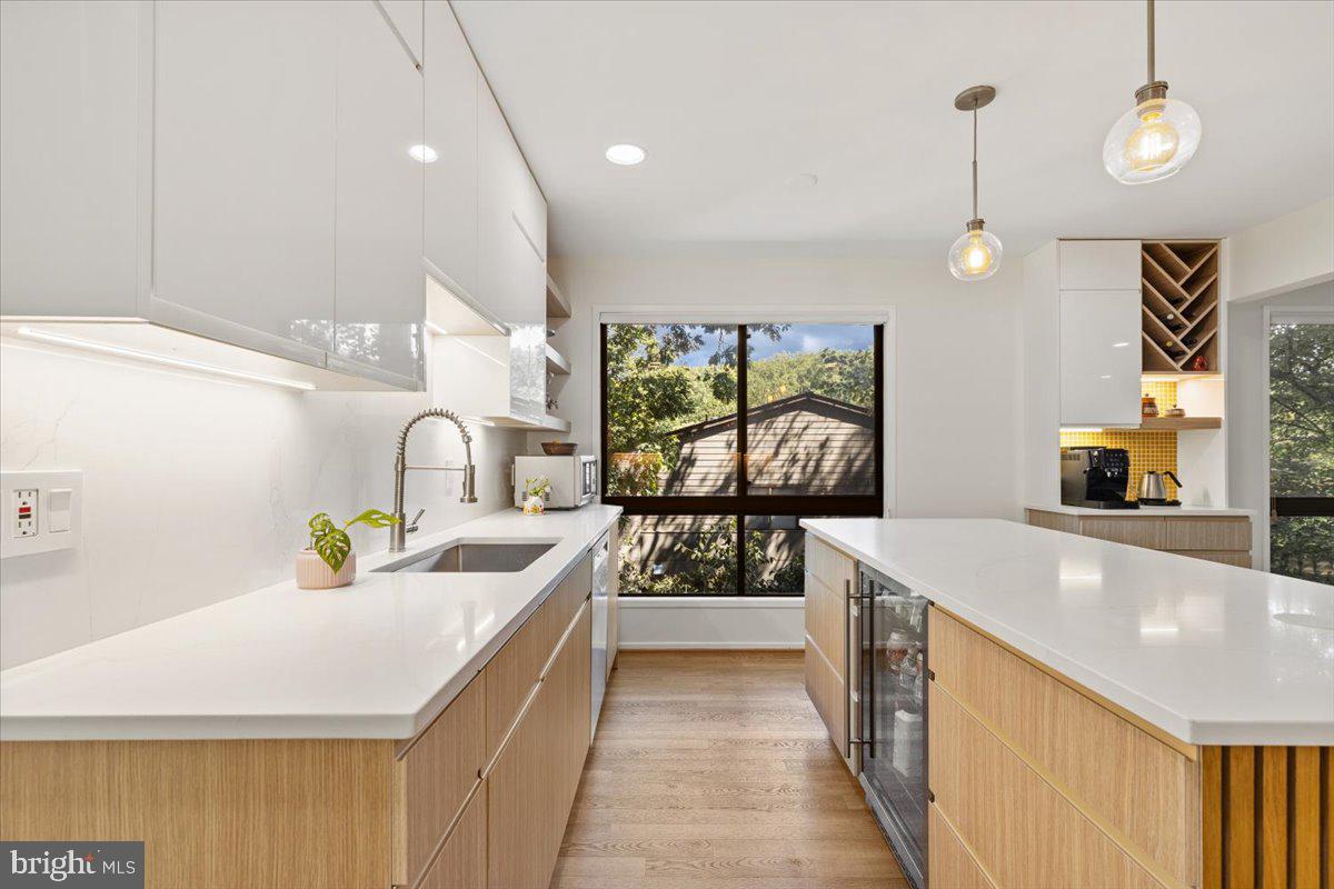 9411 Fernwood Road Bethesda, MD 20817 - Photo 17 of 101 a kitchen with stainless steel appliances a sink a stove top oven a chimney and a center island