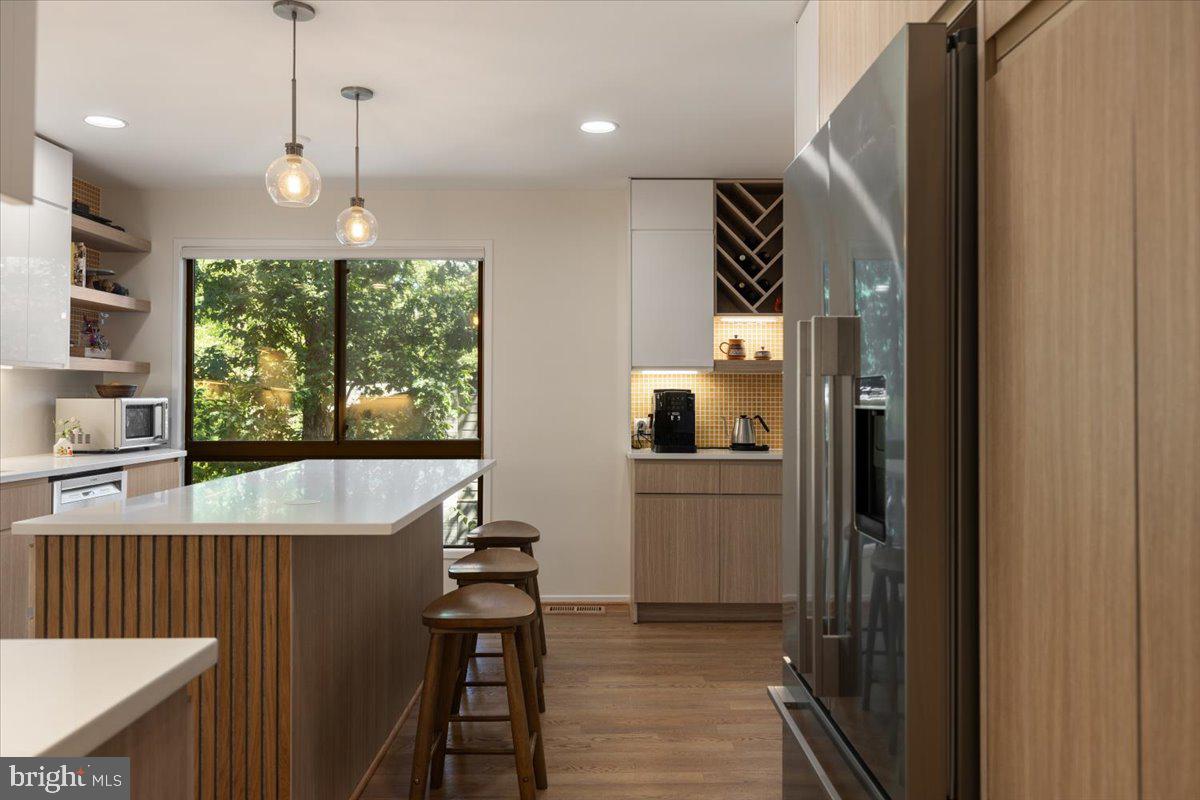 9411 Fernwood Road Bethesda, MD 20817 - Photo 23 of 101 a kitchen with kitchen island a large window cabinets and stainless steel appliances