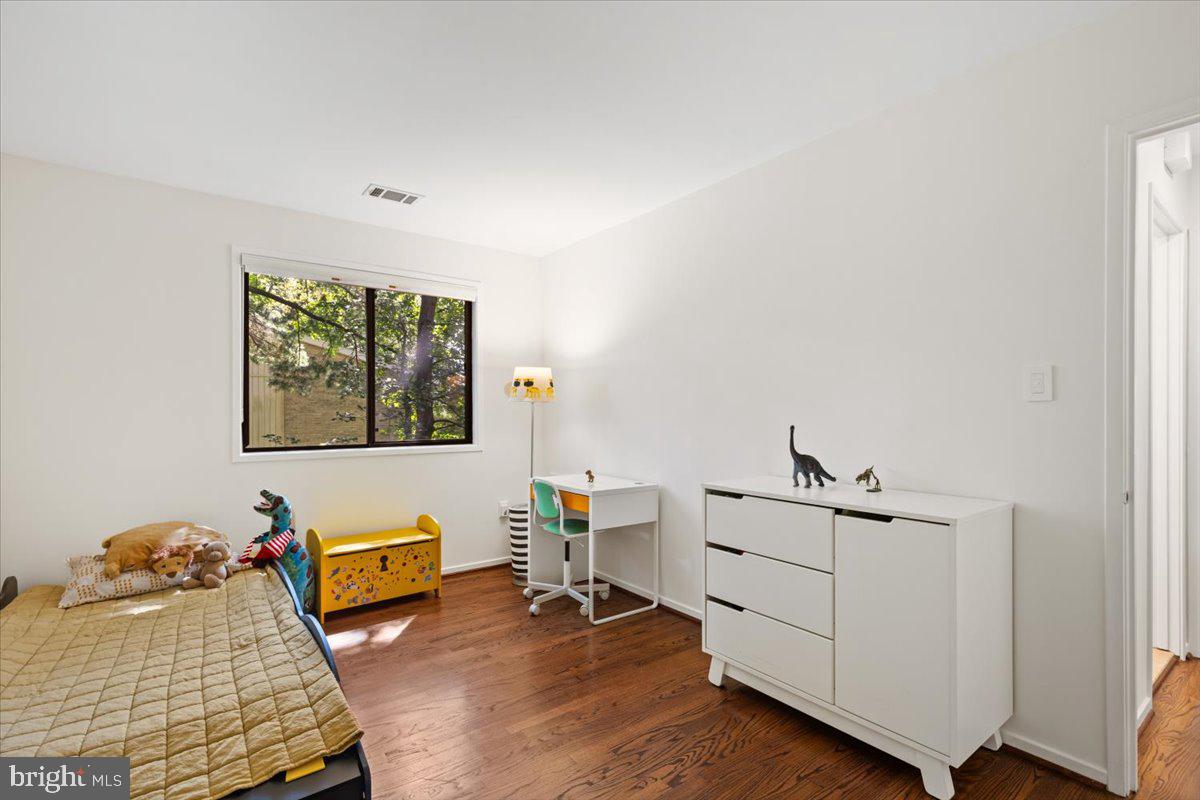 9411 Fernwood Road Bethesda, MD 20817 - Photo 43 of 101 a bedroom with furniture and a wooden floor