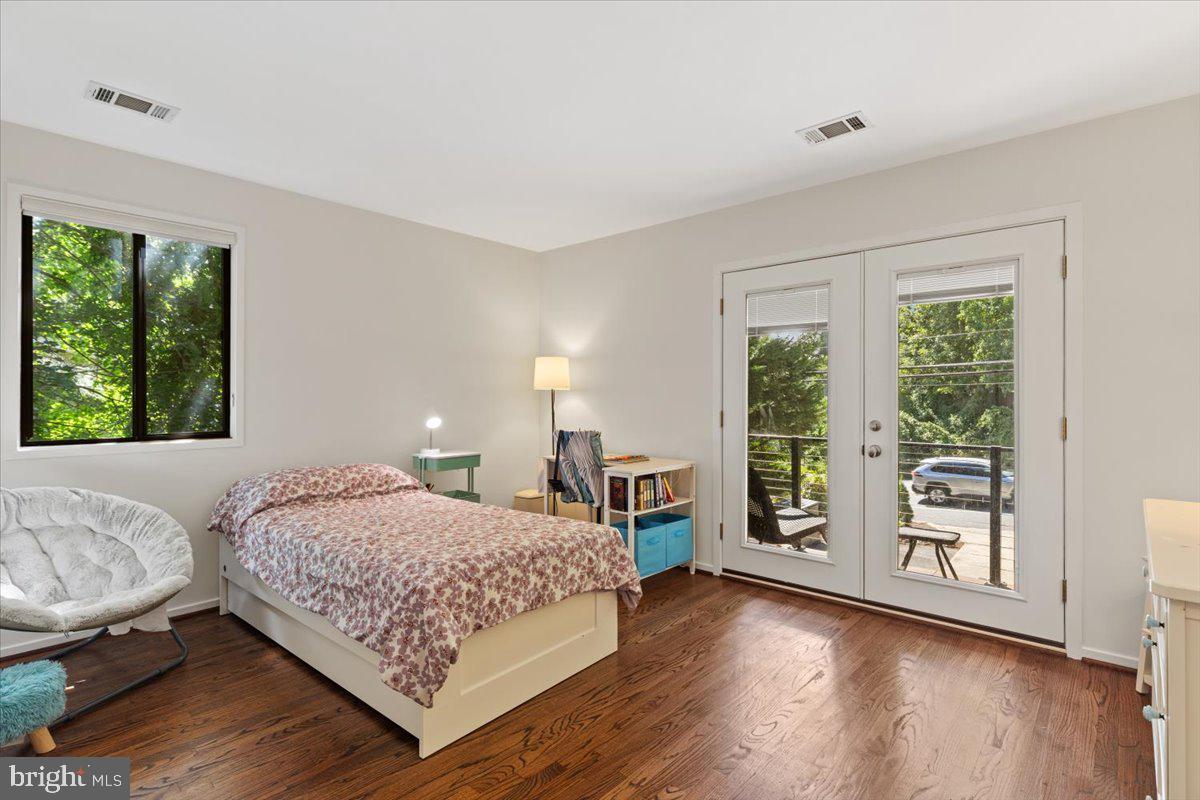 9411 Fernwood Road Bethesda, MD 20817 - Photo 45 of 101 a bedroom with a large bed and wooden floor